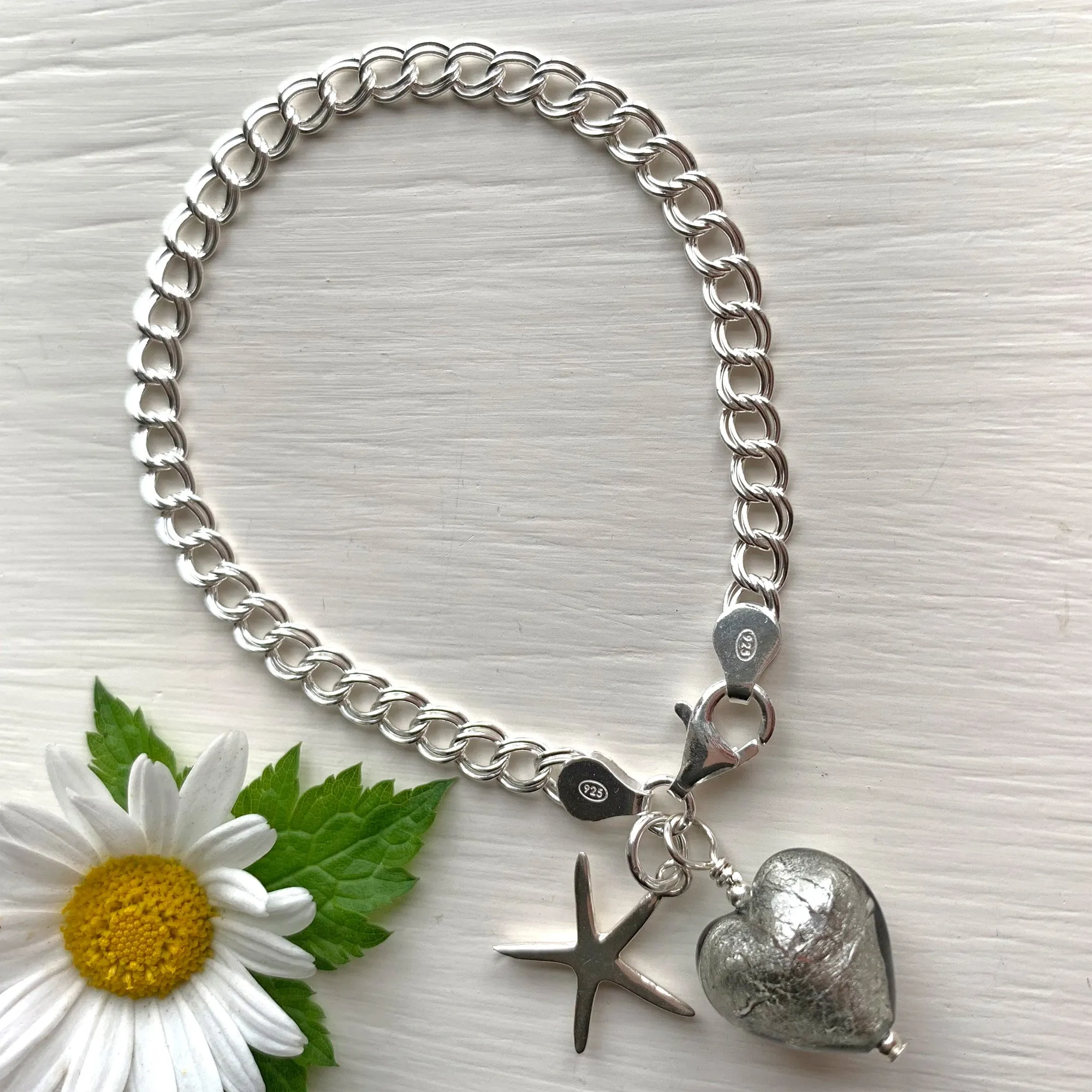 Bracelet with grey Murano glass small heart and starfish charms on silver curb chain